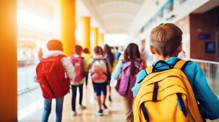 A lively group of school children with colorful backpacks strolls through a sunlit hallway, embodying youthful energy and the promise of new learning adventures.