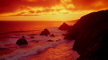 Obraz premium Magnificent Sunset Over Rugged Coastal Cliffs and Crashing Waves