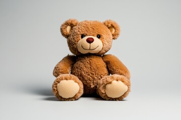 Obraz premium Single teddy bear doll sitting alone, with soft, muted colors and no background, emphasizing its comforting and nostalgic presence