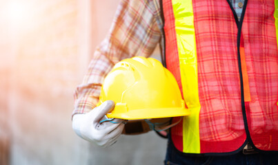 Construction Worker Holding a Safety Helmet