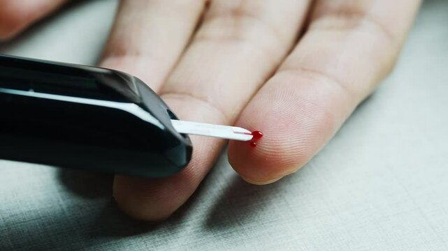 Man's hands checking diabetes and hyperglycemia with digital blood sugar meter. Healthcare and medical concept	