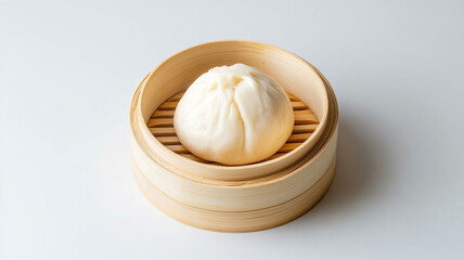 Steamed bun with smooth white surface sits in bamboo steamer, showcasing its soft texture and inviting appearance. Perfect for delicious meal or snack