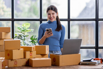 Entrepreneurs small business SME independent asian woman work at home use calculator on phone and...
