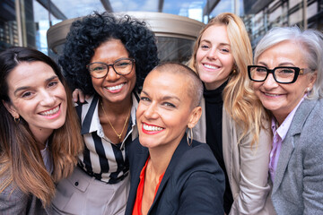 Team of women entrepreneurs having a selfie with an outdoor partner.