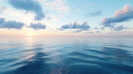 Obraz premium A serene ocean view at sunrise, with soft blue hues in the sky reflecting on the calm waters below, creating a peaceful and calming scene.