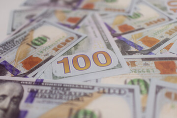 Blue and orange US  dollar bills spread out, representing wealth, cash flow, and financial growth in global and domestic markets.