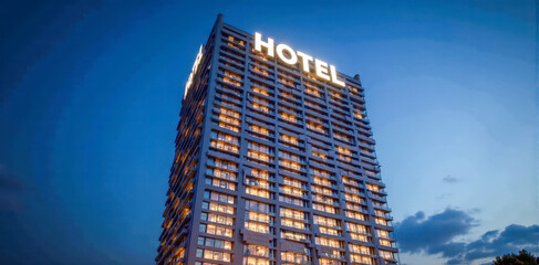 Modern hotel building exterior illuminated at twilight, urban accommodation, high-rise architecture, city travel lodging destination, evening sky backdrop
