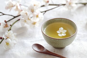 A serene moment with green tea and delicate spring blossoms in a tranquil setting