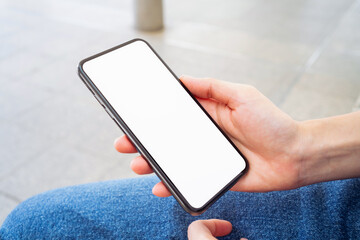 Hand holding smartphone mockup of blank screen, Take your screen to put on advertising.
