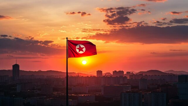 The North Korean flag waves in the wind as the sun sets over Pyongyang