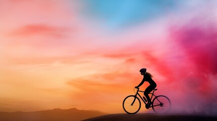 Naklejka premium Adventurous Cyclist Silhouetted Against Colorful Sky