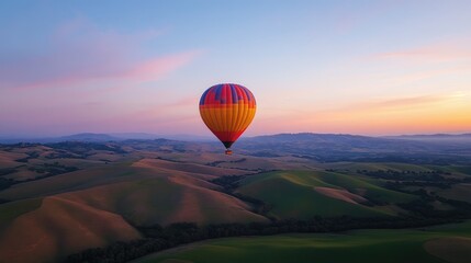Fototapeta premium A balloon highlighted against the twilight sky, with rolling hills in the distance. No people.