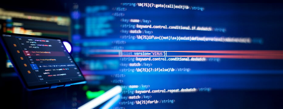 Writing programming code on laptop. Software source code. Programming code. Abstract IT technology background.