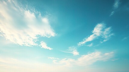 Fototapeta premium Clear Blue Sky with Soft Clouds Above