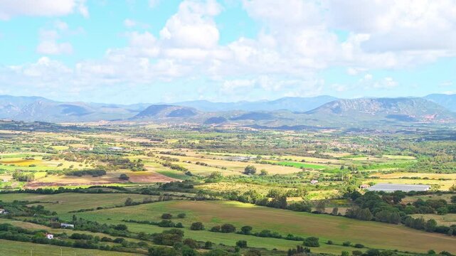 Sirai, Sardinia view from archaeological park of Monte Sirai, Italy with farm farming fields by rolling hills and mountains
