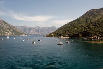 Side view of the Bay of Kotor. View of yachts and liners. Blue sea and mountains