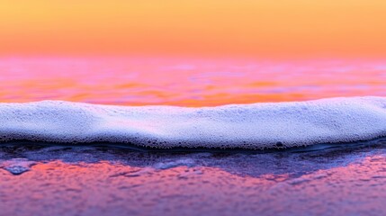 Obraz premium Sunset Surf: Serene ocean wave gently washing ashore at sunset, pastel colors, calm beach scene