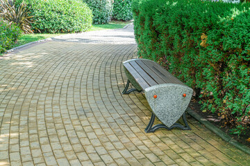 Modern bench design in a landscaped garden surrounded by greenery