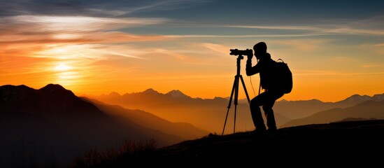 Photographer Capturing Sunset on Mountain Horizon