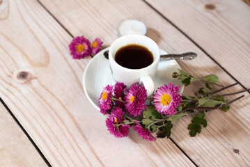 Autumn, fall leaves, hot steaming cup of coffee and a warm scarf on wooden table background. Seasonal, morning coffee, Sunday relaxing and still life concept.