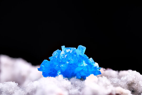 Blue Cavansite crystals on stilbite. macro photography detail texture background. close-up mineral crystal unpolished semi-precious gemstone
