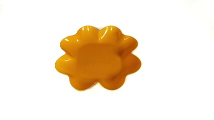 flower shaped plate that colored orange wtih white isolated background
