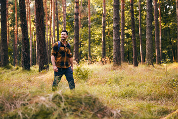 Fototapeta premium Hiker walking in forest during autumn trip