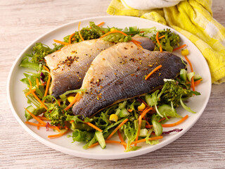  fish fillets over salad