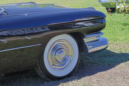 Black cadillac coupe deville showing front wheel and bumper