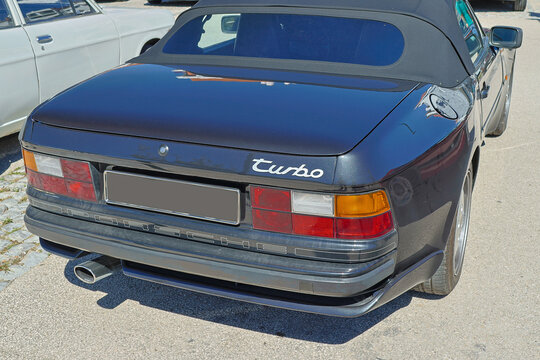 Black porsche 944 turbo cabriolet parked on a sunny day