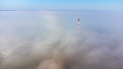 clear sunny morning over the city with tall buildings in the fog © Stepan