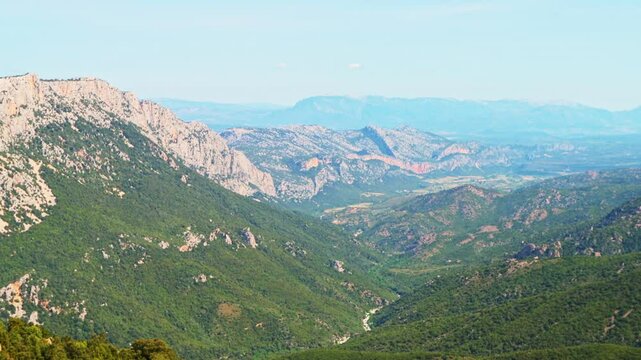 Gorropu canyon hiking trail path, hike to famous gorge in Sardinia with Sardinian mountains cliff nature forest landscape in summer of Italy