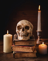 Skull Surrounded by Antique Books and Candles