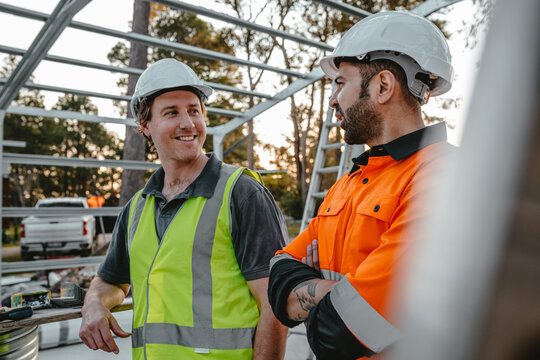 Construction workers looking at each other at the construction site having a conversation