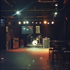 Dimly lit stage with instruments awaiting musicians; cozy ambiance with moody lighting, a perfect setup for intimate live performances.