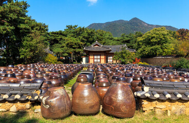 Woodang House, Boeun-gun, Korea - October 21, 2019: Many crocks(Jangdok) are placed in the yard at a traditional korean tile-roofed house. Jangdok is a jar to contain soy sauce and red pepper paste.