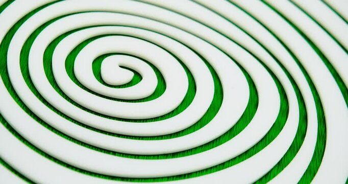 endless hypnotic irregular white spiral made of cast acrylic sheet on green background