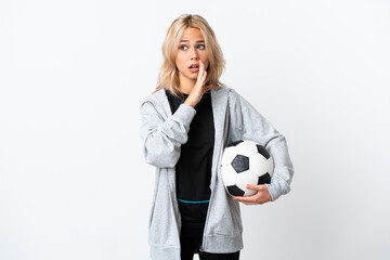 Young Russian woman playing football isolated on white background whispering something with surprise gesture while looking to the side