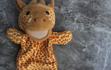 Cute Giraffe Puppet on Marble Background for Playful Fun