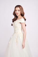 Fototapeta premium Beautiful young asian woman in wedding dress on white background,
