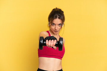 Naklejka premium Young caucasian woman isolated on blue background making weightlifting
