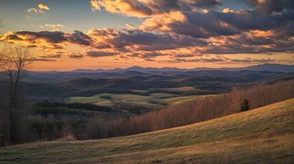 Obraz premium Sunset Over Rolling Hills and Distant Mountains
