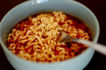 noodles in tomato sauce in a gray bowl on the table
