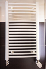 heating radiator in the bathroom with temperature controller