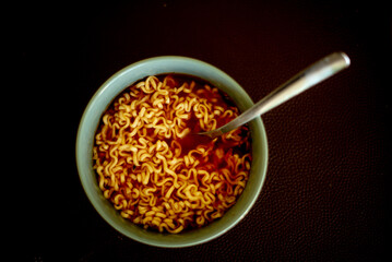 noodles in tomato sauce in a gray bowl on the table
