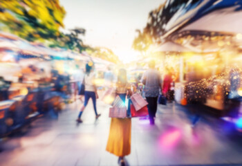 Naklejka premium A blurred view of people walking along a shopping street.