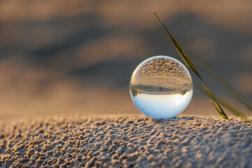 Sunset on the beach through a crystal ball
