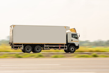 Side view of a small truck driving on a country road, truck running on the road, small truck on the road.