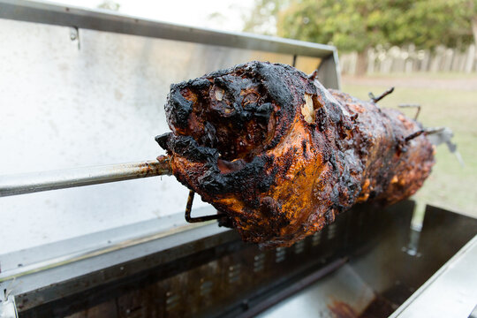 a whole animal cooking on a spit roast