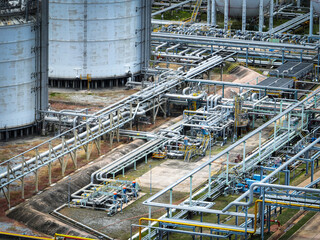 Industrial oil refinery and petrochemical plant with extensive steel pipelines and gas storage tanks. Infrastructure for the energy and fuel. Oil and gas refinery plant. Network of pipes and tanks.